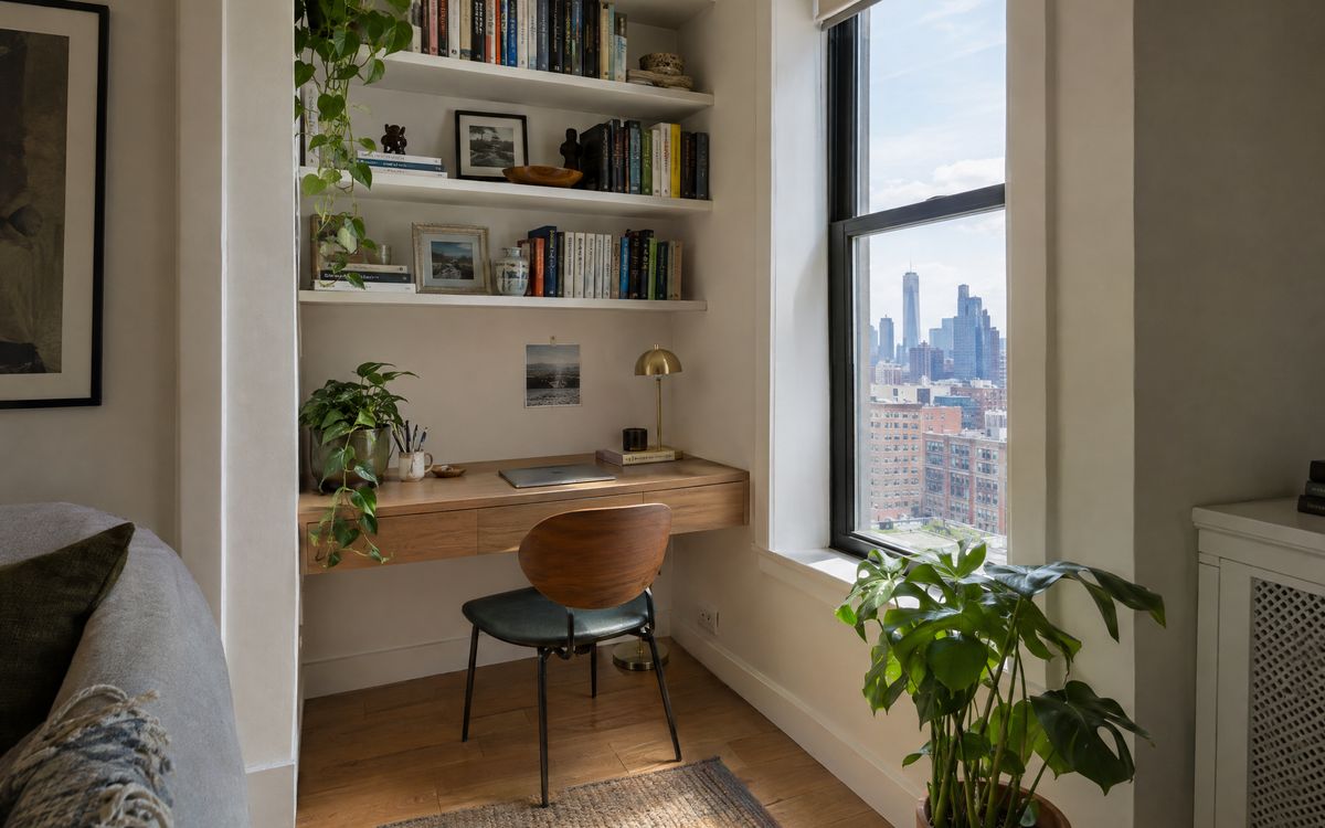 A floating built-in desk with shelves to the ceiling tucked into a Manhattan apartment alcove, design concept